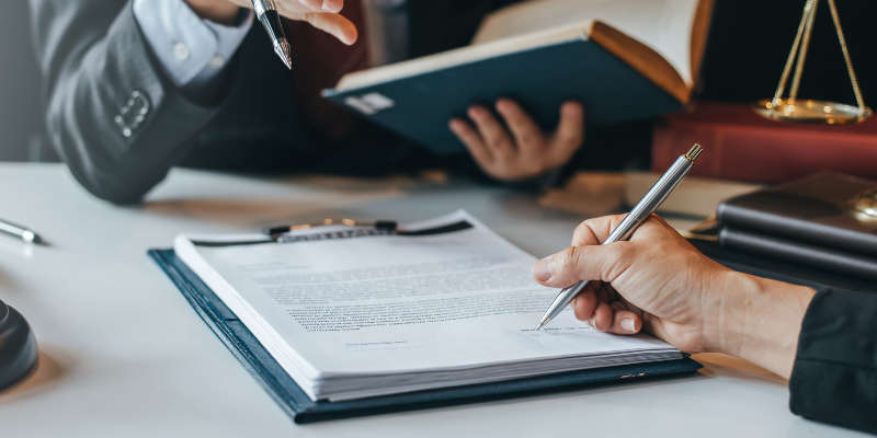 man signing documents