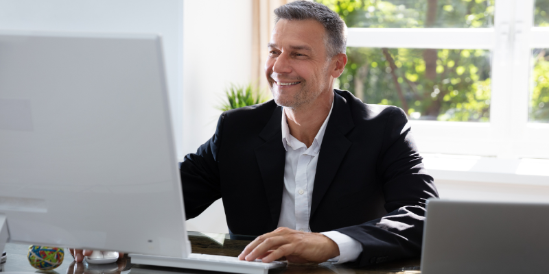 a man smiling from working remotely