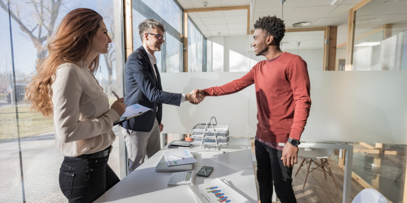two men firmly shaking hands