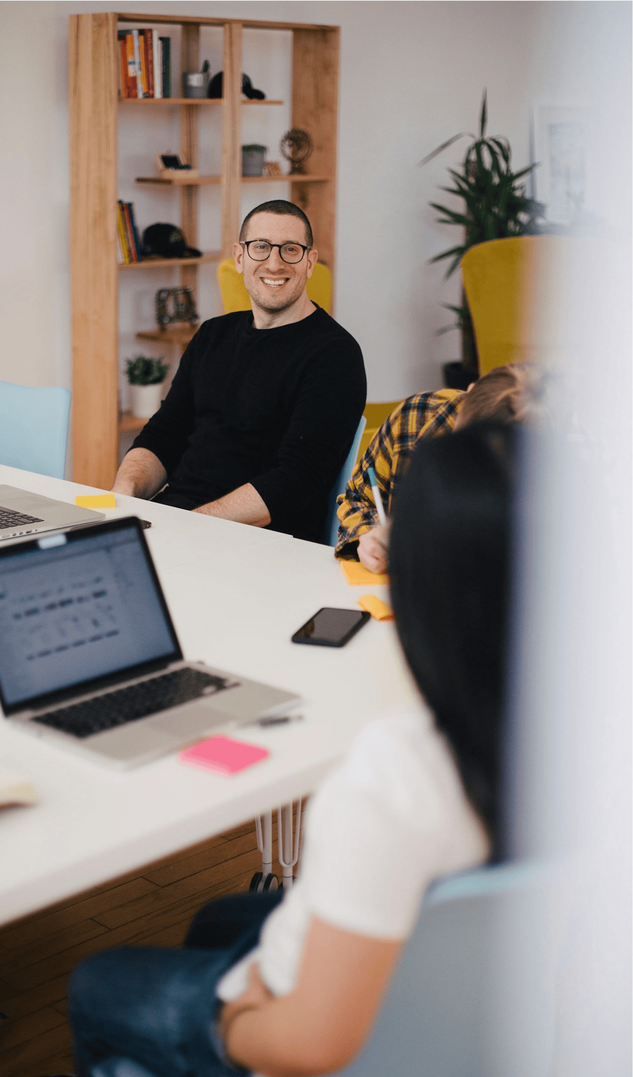 Man at table smiling while working
