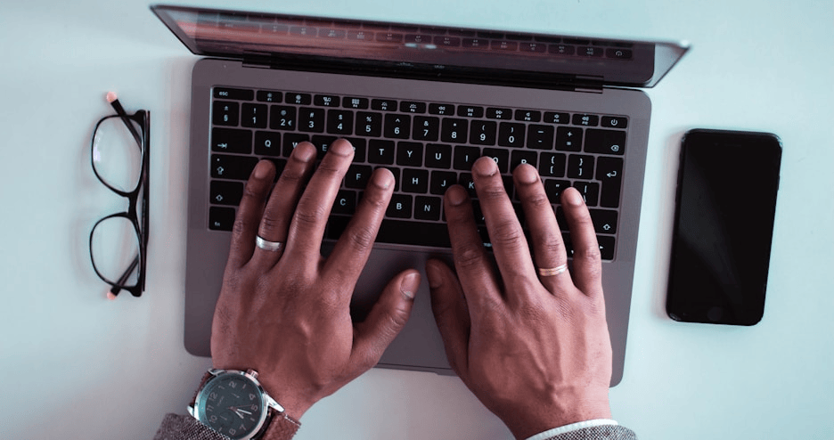 Overhead shot of mans hands on a computer